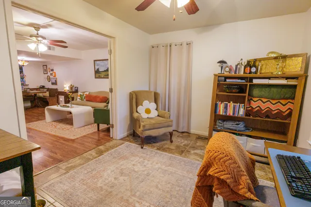 a bedroom with furniture and a flat screen tv