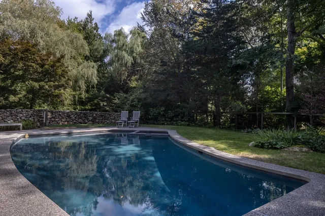 a view of a backyard with swimming pool
