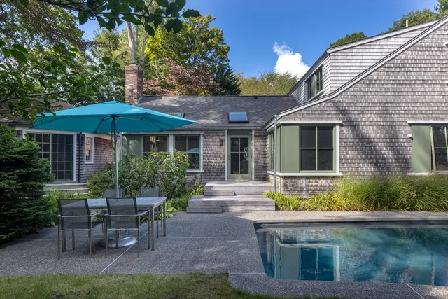 a view of house with a yard and sitting area
