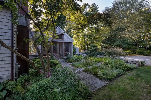 a front view of a house with yard and green space