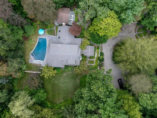 an aerial view of a house with a yard