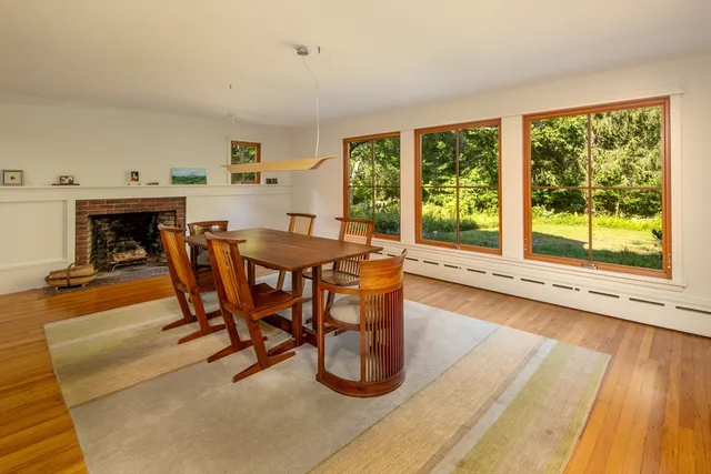 a dining room with furniture and a floor to ceiling window