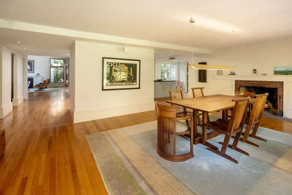 a dining room with furniture and wooden floor