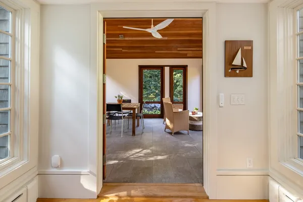 a living room with furniture and a dining table with rug