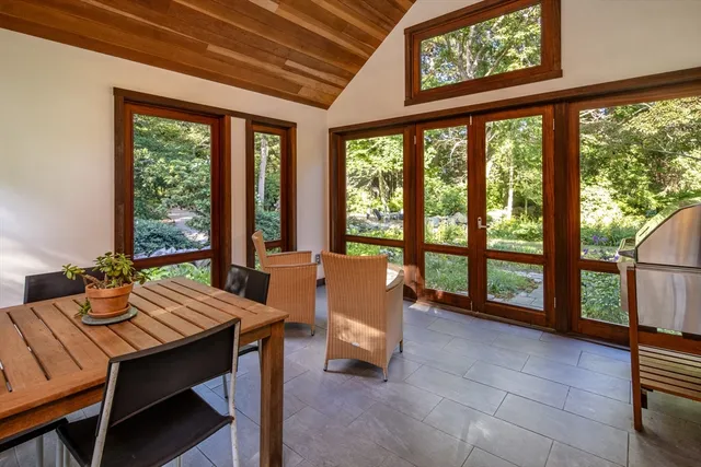 a room with pool table and windows