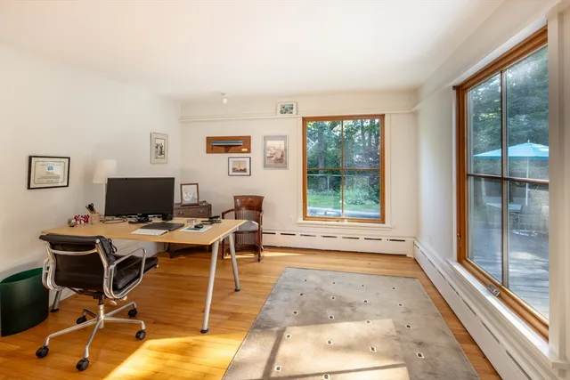 a workspace with wooden floor and a window