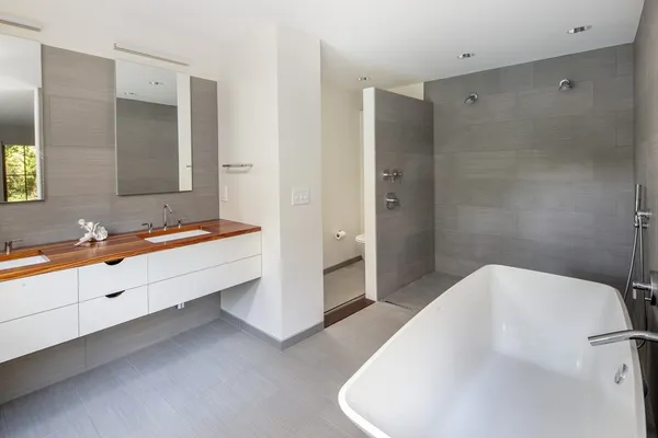 a spacious bathroom with a bathtub sink and mirror