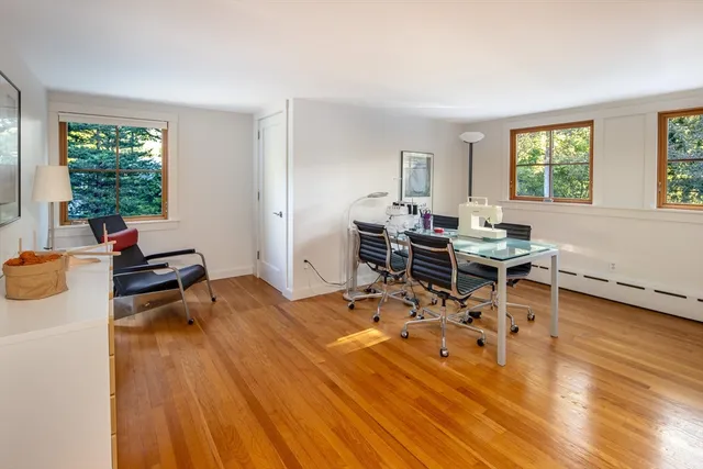 a living room with furniture a wooden floor and a window