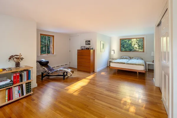 a bedroom with furniture and a book shelf