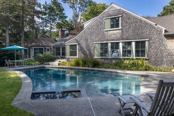 a view of a house with pool yard and furniture