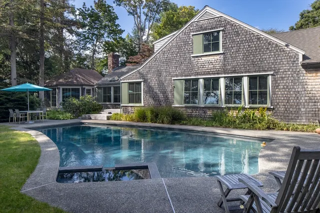 a view of a house with pool yard and furniture
