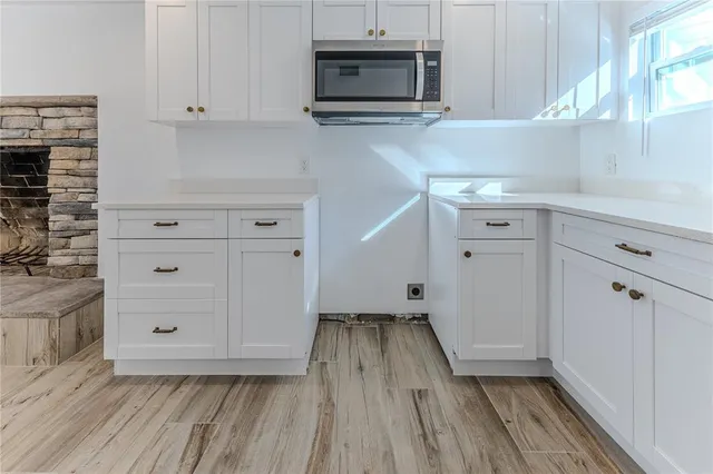 a view of empty room with wooden floor and flat screen tv