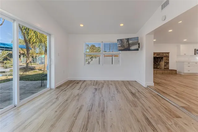 a view of a house with a yard and tree