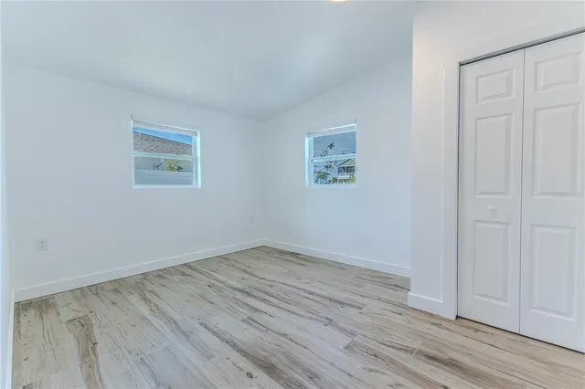 a view of a ocean with boats and trees in the background