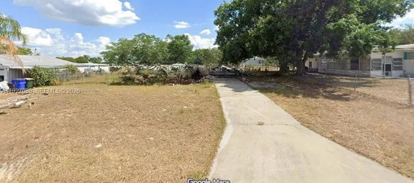 a view of a yard with cars