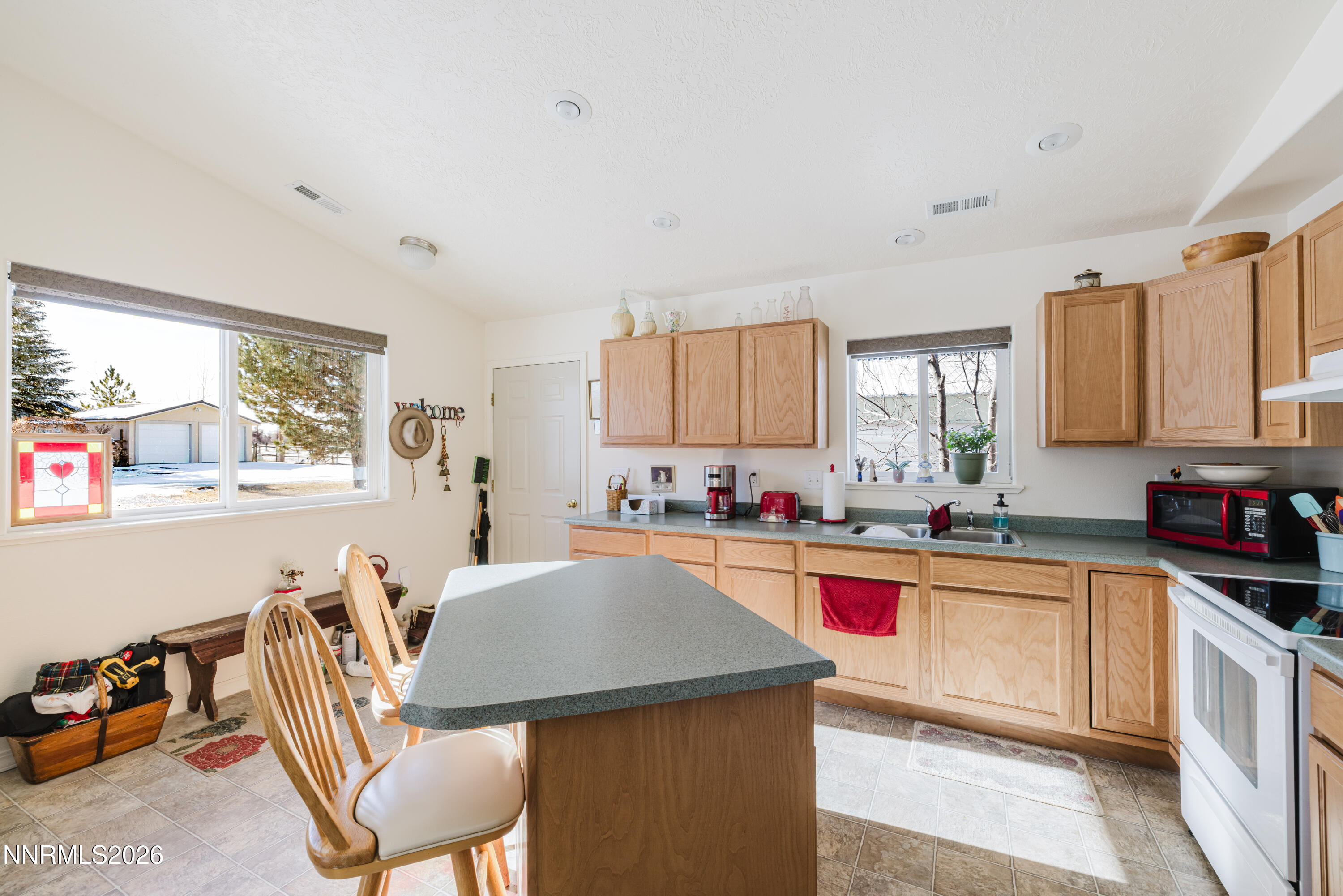2013 Blume Ranch Road Lamoille, NV 89828 - Photo 29 of 37 a kitchen with a stove a sink a dining table and chairs