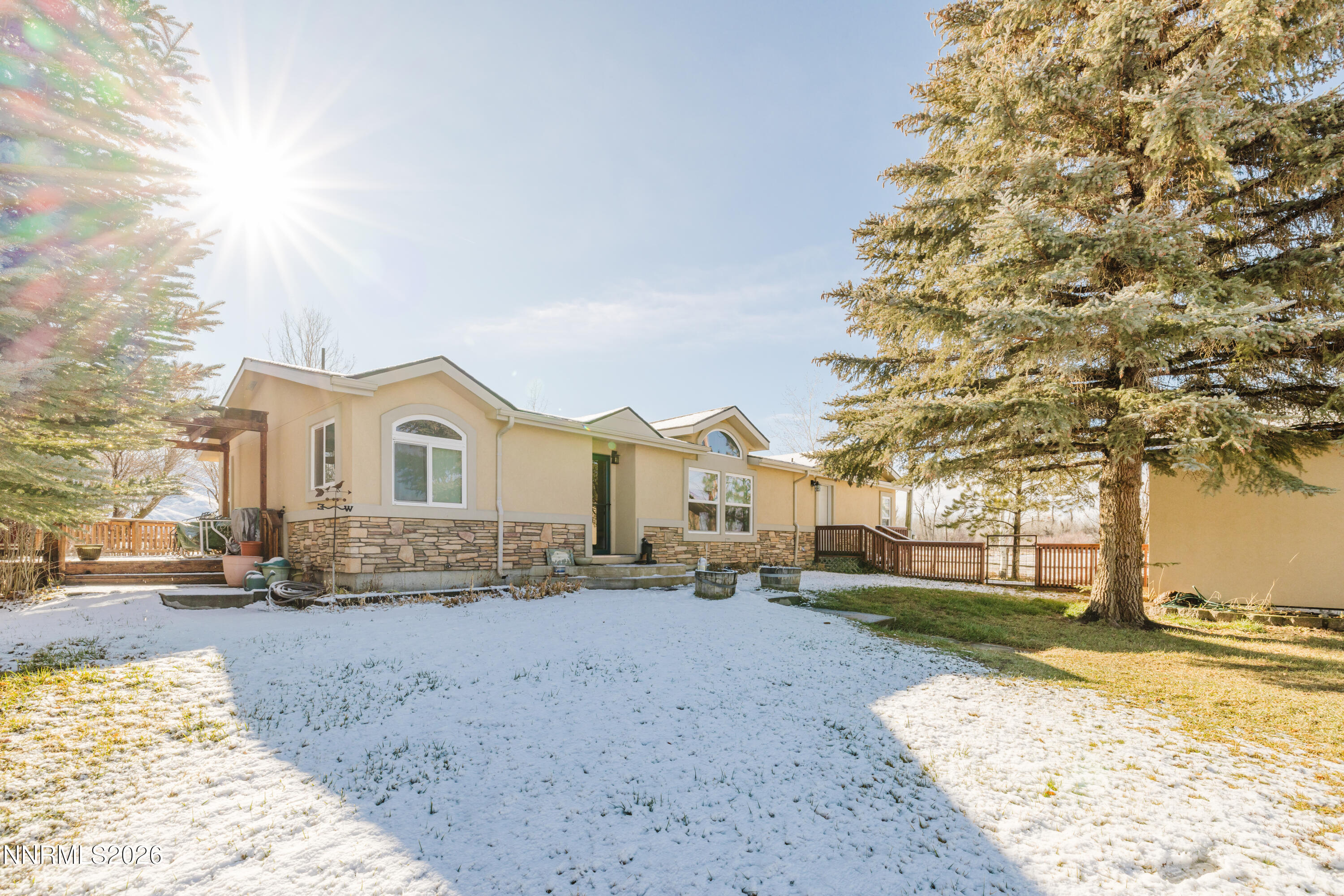 2013 Blume Ranch Road Lamoille, NV 89828 - Photo 7 of 37 a view of a white house with a yard covered in snow