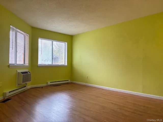 a view of a room with wooden floor and windows