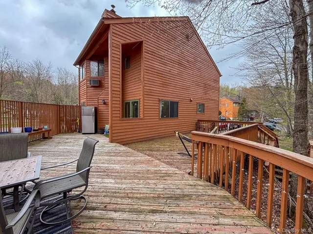 a view of house with deck and outdoor seating