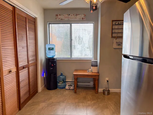 a view of kitchen with refrigerator and window