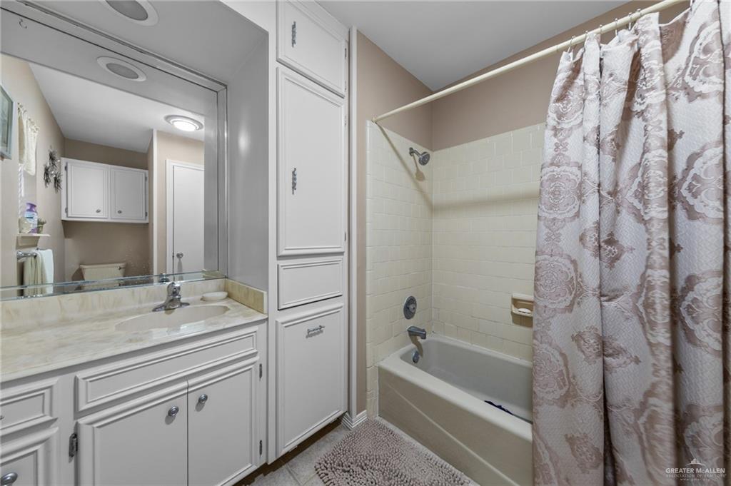 1514 Walnut Court Harlingen, TX 78550 - Photo 16 of 24 Full bath with shower / bath combo, vanity, and light tile patterned flooring