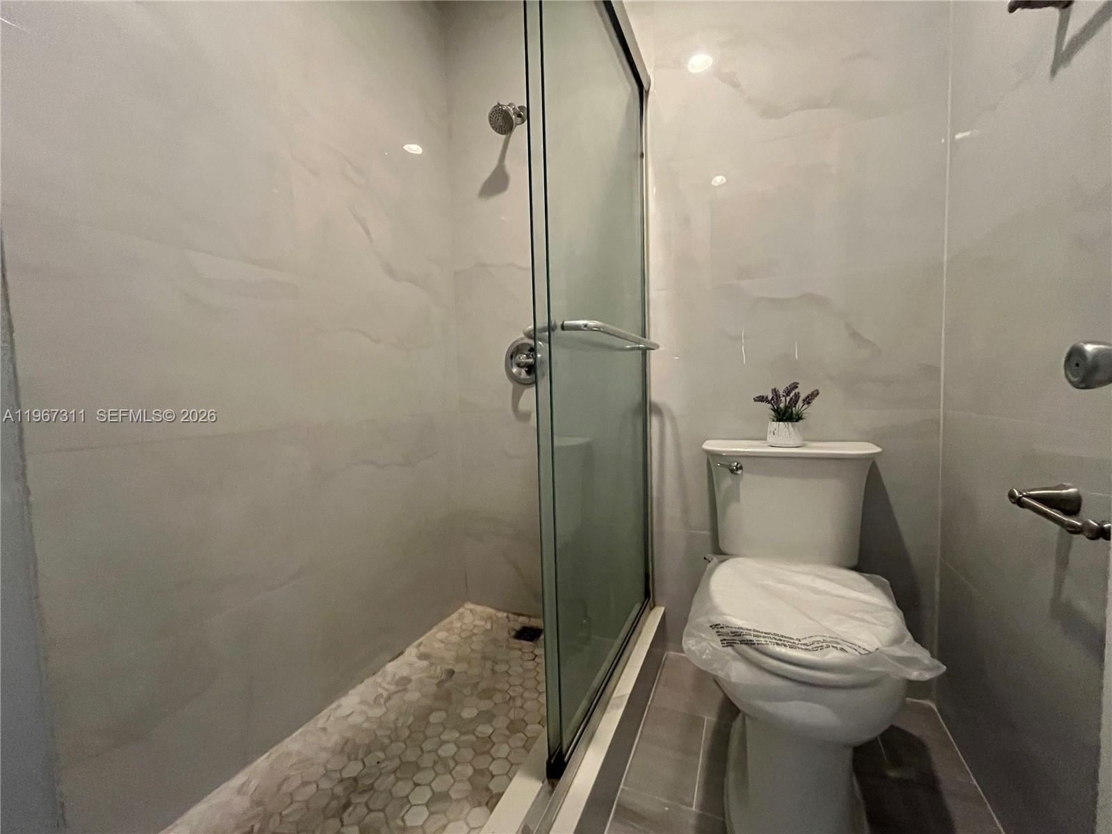 5150 Lake Loop Road Cooper City, FL 33330 - Photo 13 of 22 a bathroom with a toilet sink and shower