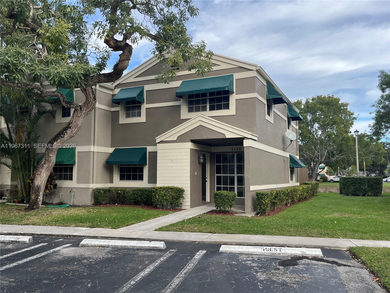 5150 Lake Loop Road Cooper City, FL 33330 - Photo 2 of 22 a front view of a house with a yard