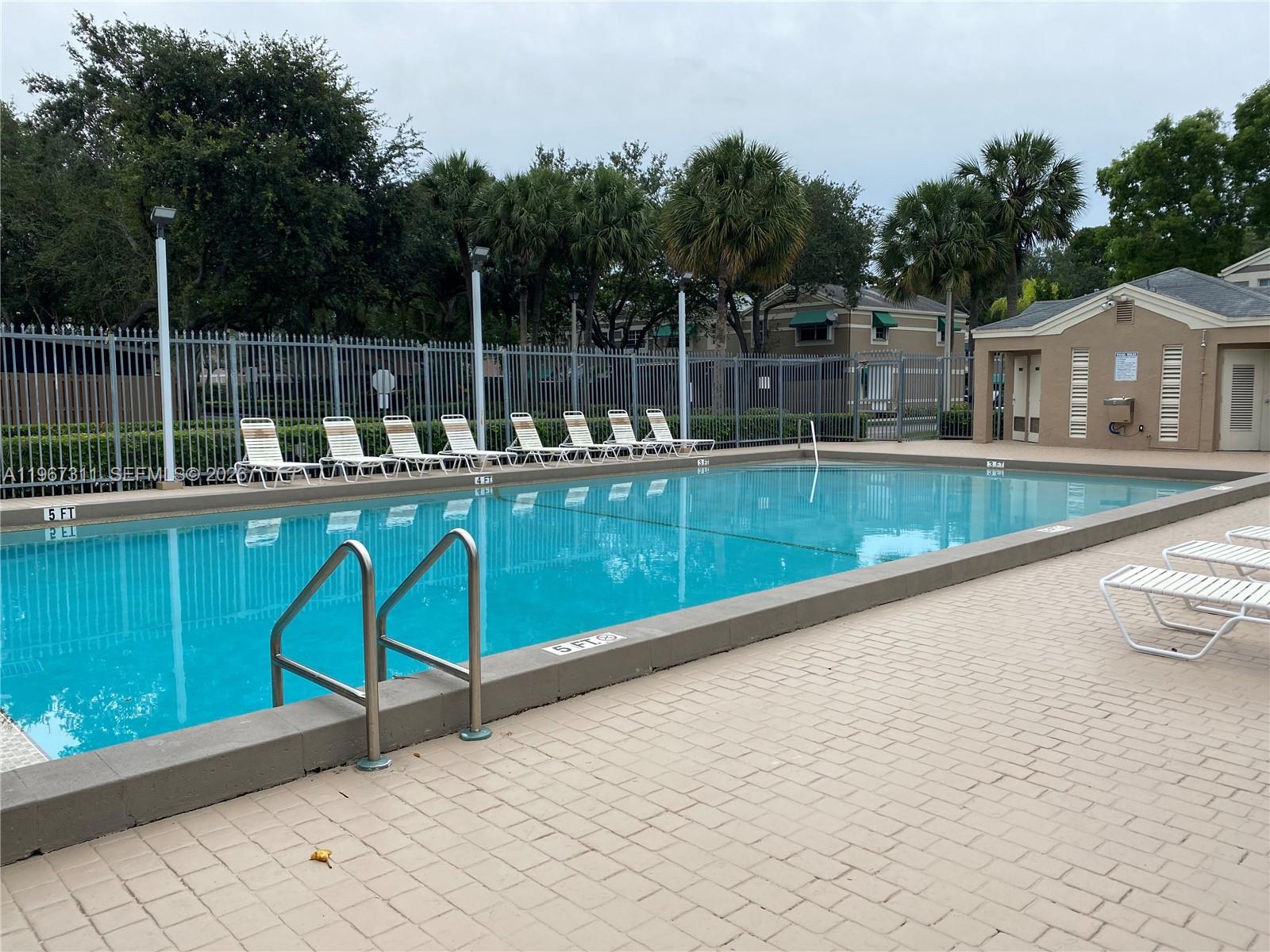 5150 Lake Loop Road Cooper City, FL 33330 - Photo 22 of 22 a view of a chair and tables on the terrace