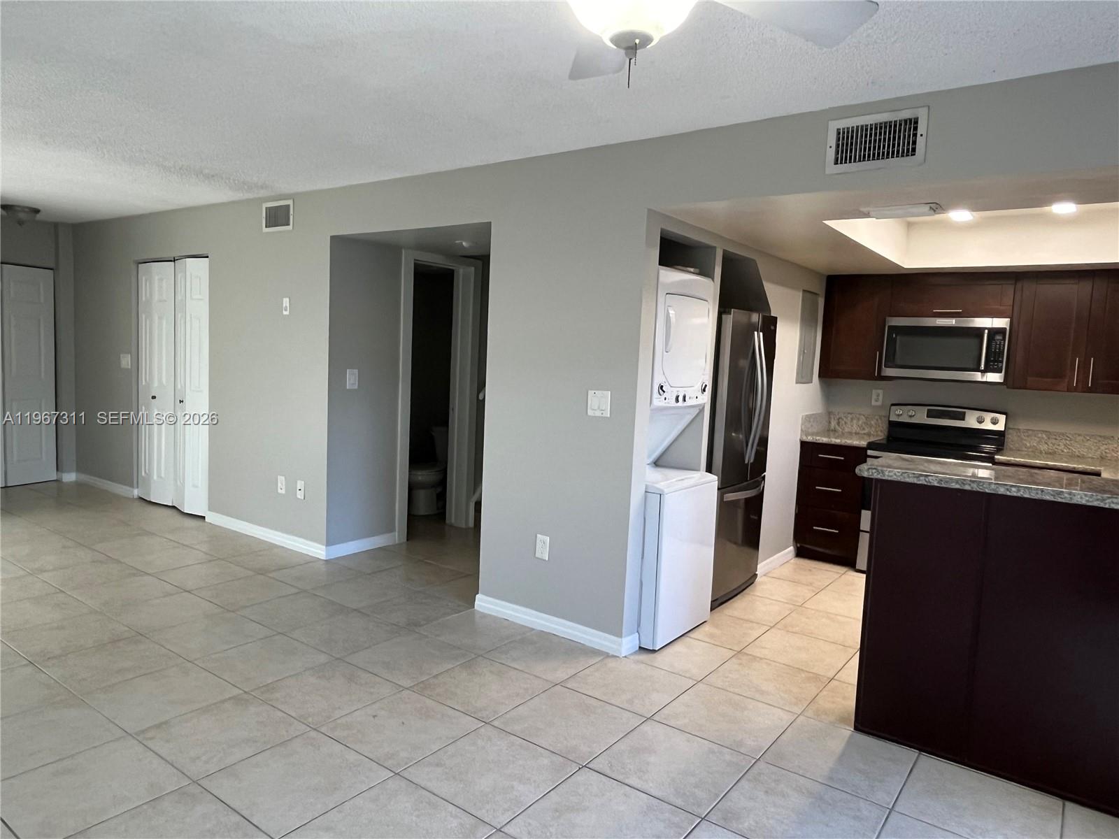 5150 Lake Loop Road Cooper City, FL 33330 - Photo 6 of 22 a kitchen with stainless steel appliances granite countertop a refrigerator and a stove top oven