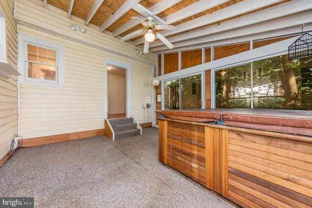 a view of a porch with wooden floor and fence