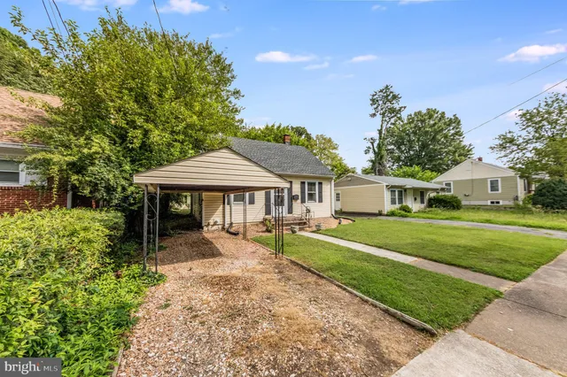 a front view of a house with yard patio and green space