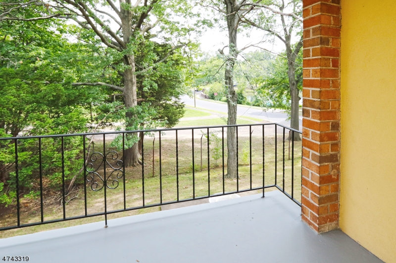 2 Westervelt Place, Unit C203 Clifton, NJ 07011 - Photo 2 of 11 a view of a balcony with tree s