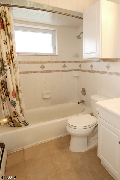 2 Westervelt Place, Unit C203 Clifton, NJ 07011 - Photo 6 of 11 a bathroom with a toilet a sink and a bathtub