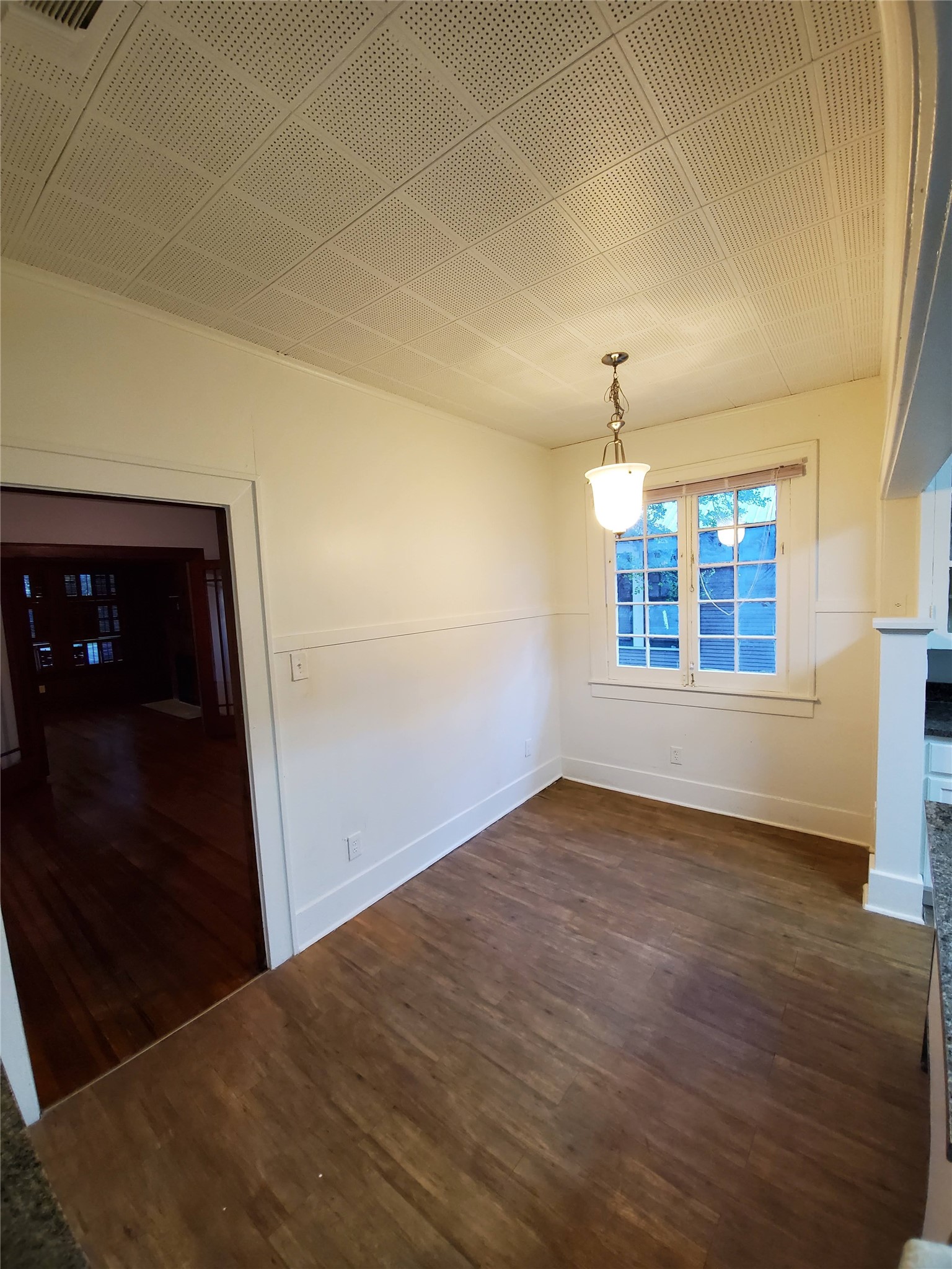 4113 Speedway Austin, TX 78751 - Photo 14 of 31 Classic wood-look flooring and a textured ceiling define this versatile dining area.