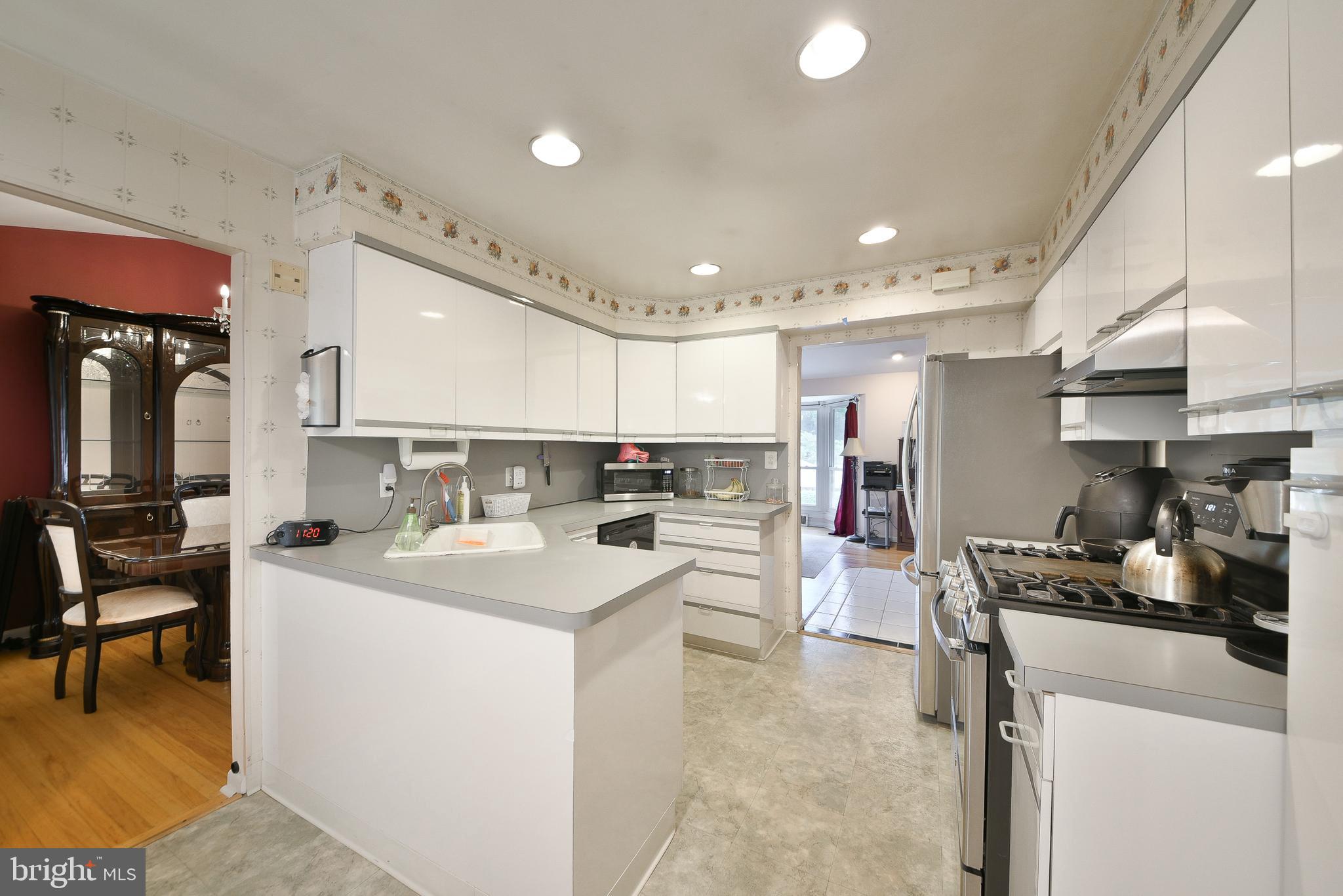 1035 Old Ford Road Huntingdon Valley, PA 19006 - Photo 11 of 39 a kitchen with a sink a stove and chairs