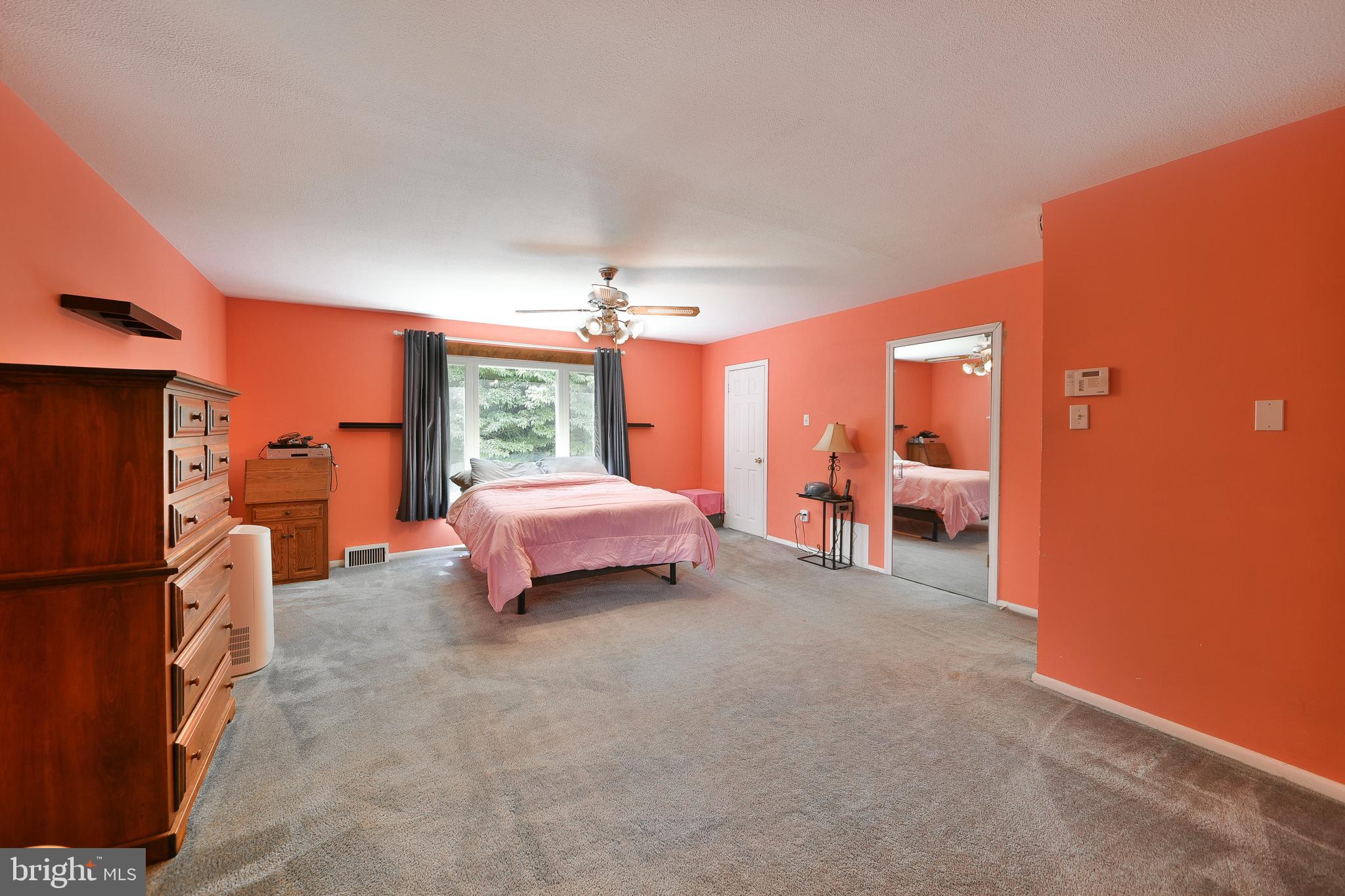 1035 Old Ford Road Huntingdon Valley, PA 19006 - Photo 20 of 39 a spacious bedroom with a bed and a chandelier