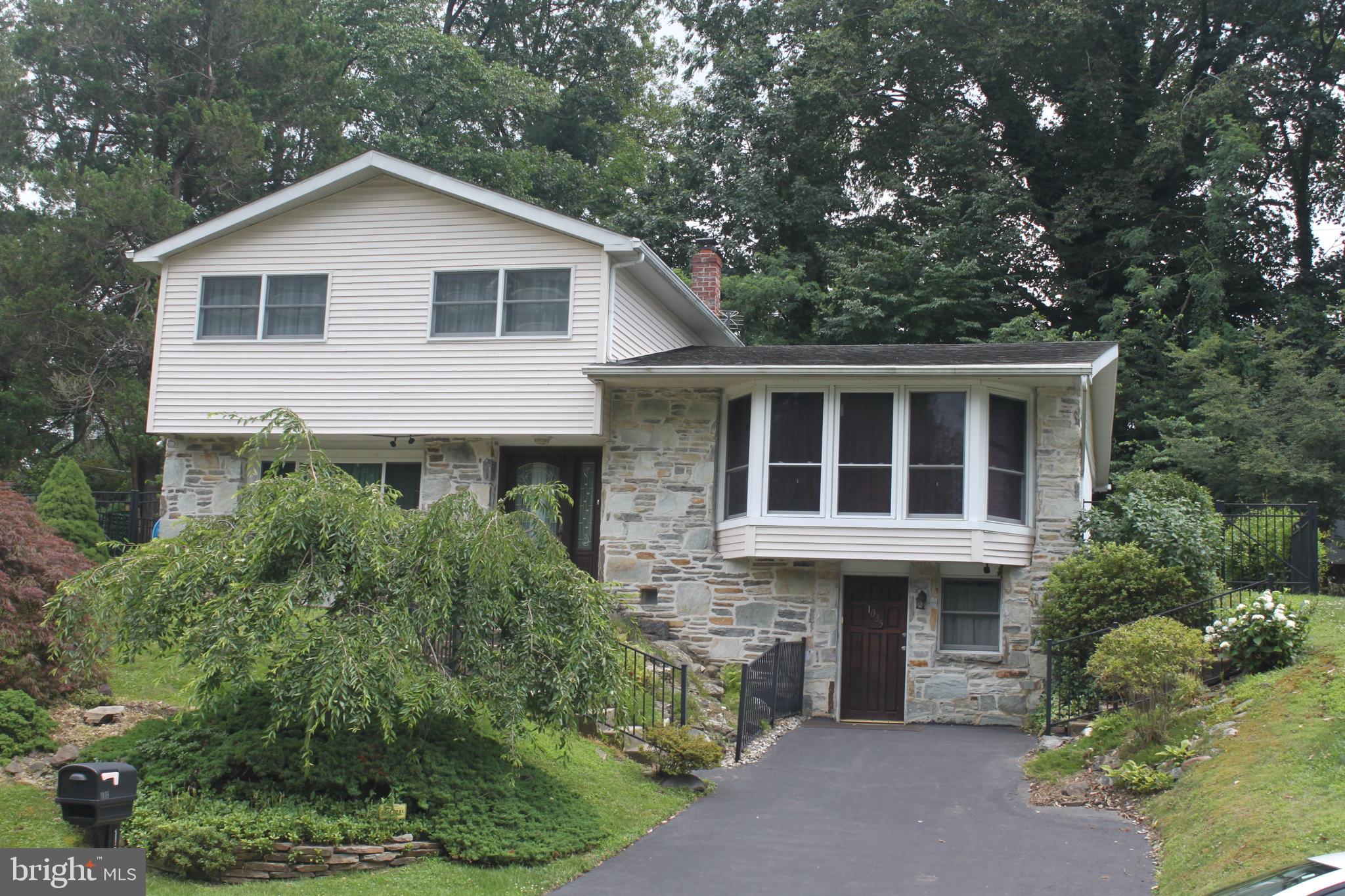 1035 Old Ford Road Huntingdon Valley, PA 19006 - Photo 2 of 39 a front view of a house with a yard and potted plants