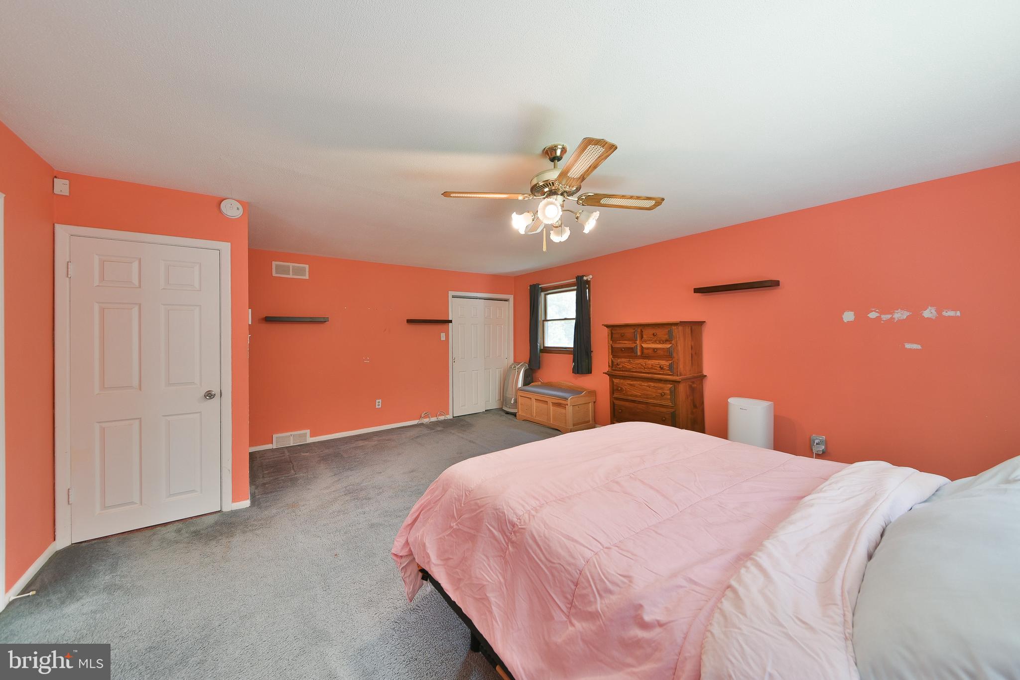 1035 Old Ford Road Huntingdon Valley, PA 19006 - Photo 21 of 39 a bedroom with a large bed and a chandelier