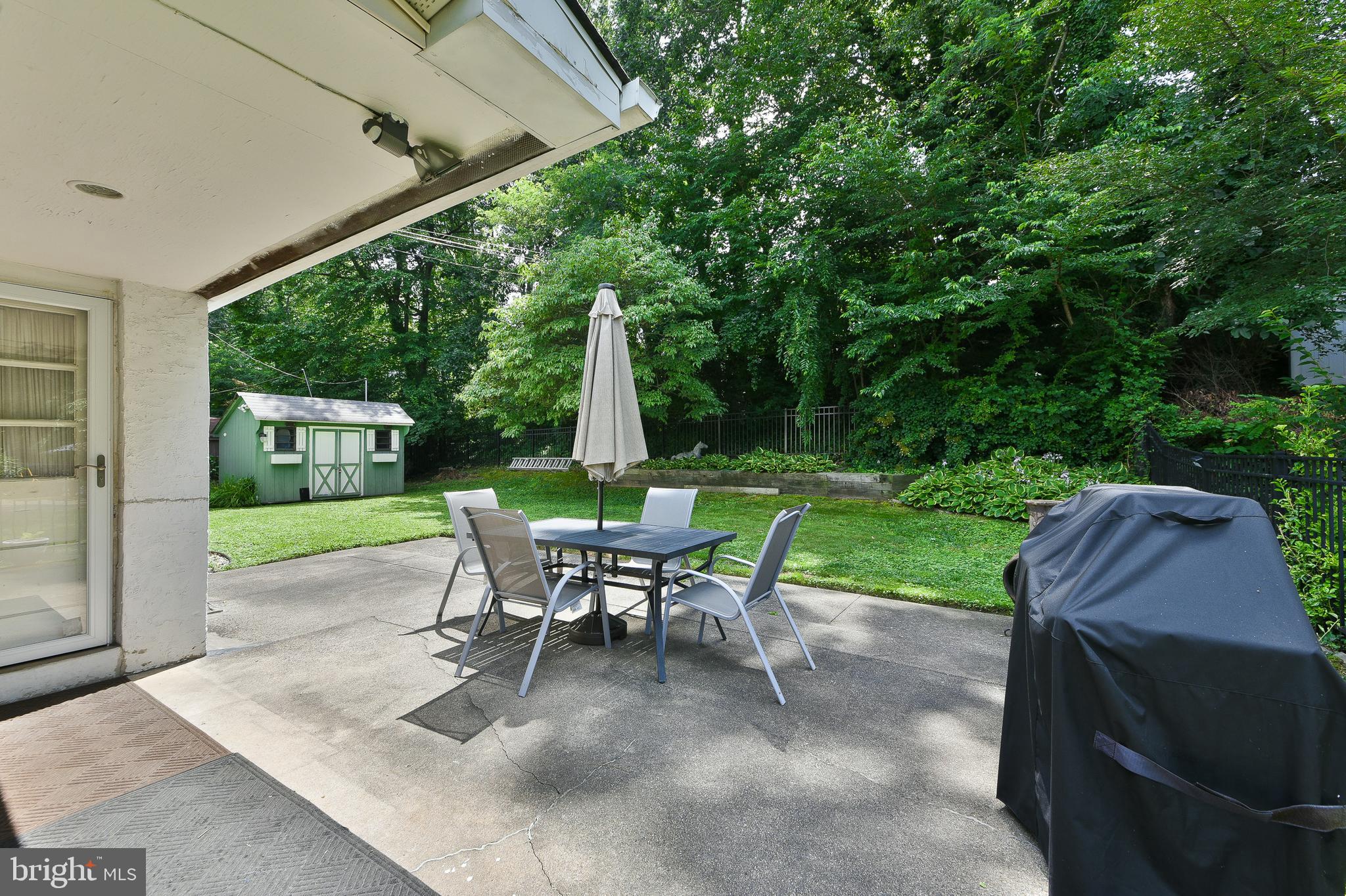 1035 Old Ford Road Huntingdon Valley, PA 19006 - Photo 32 of 39 a view of a patio with a table chairs and a backyard