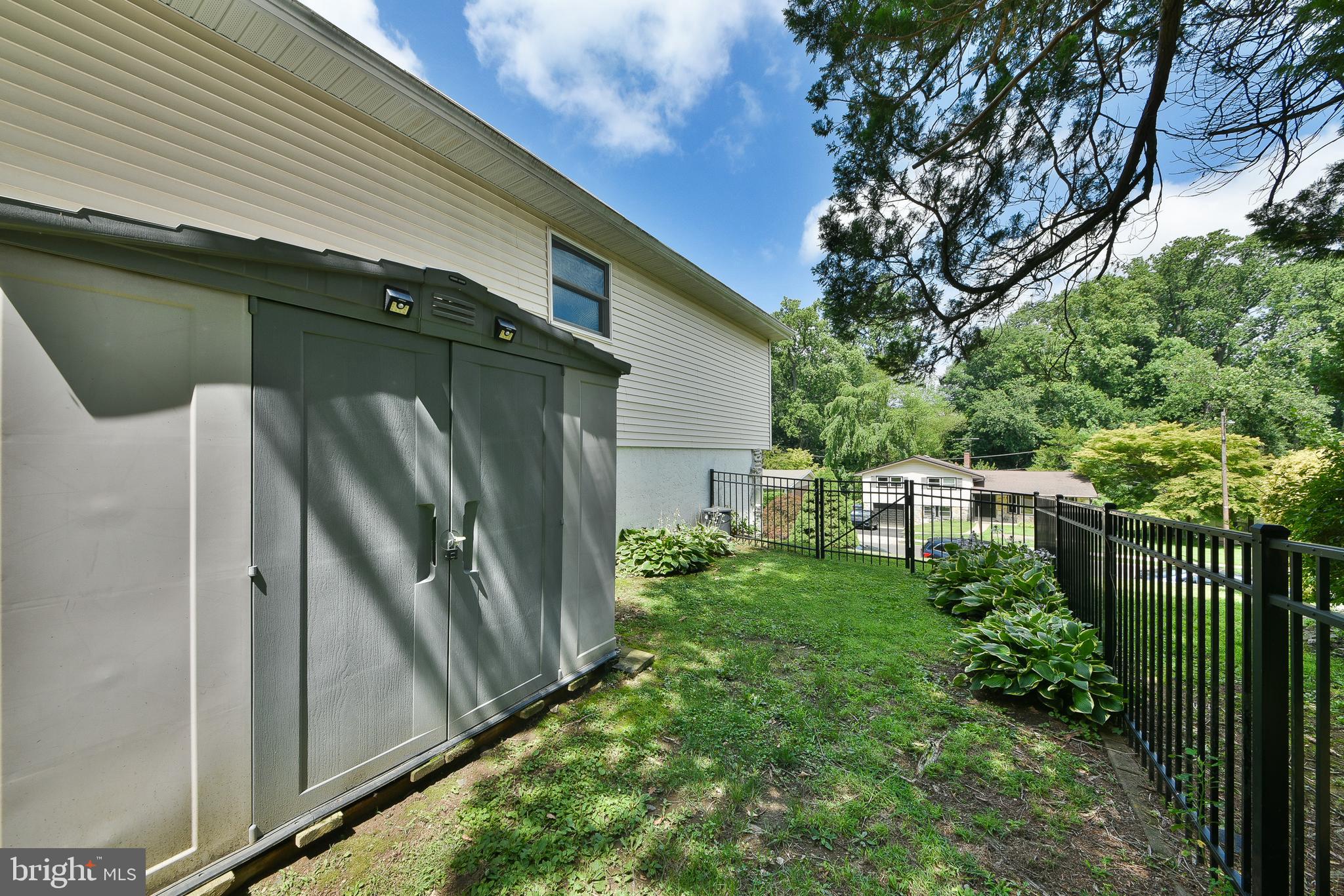 1035 Old Ford Road Huntingdon Valley, PA 19006 - Photo 38 of 39 a backyard of a house with plants and wooden fence