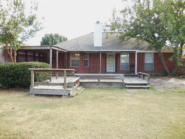 a front view of house with yard space and balcony