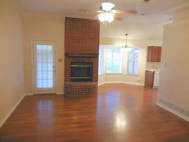 a view of a kitchen with furniture a fireplace and wooden floor