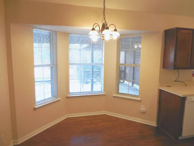 a view of a livingroom with a chandelier furniture and windows