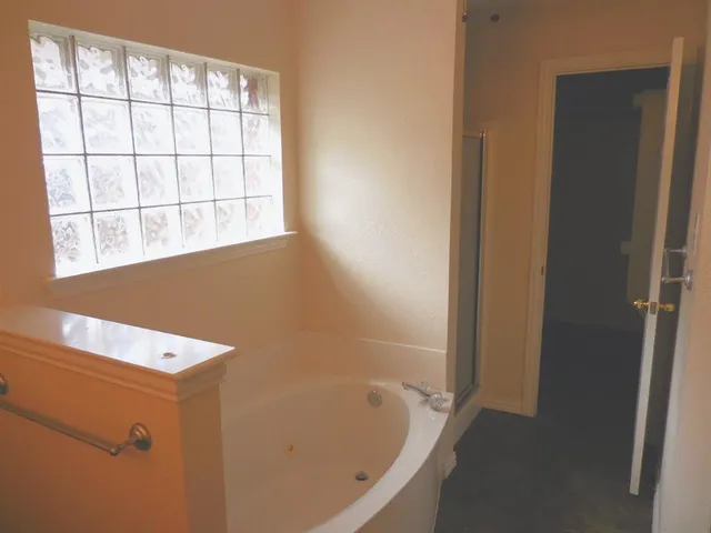 a bathroom with a bathtub and window
