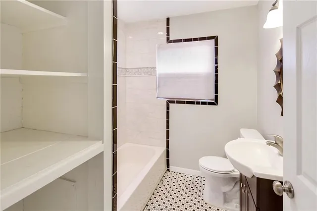 a bathroom with a shower a toilet and a bathtub