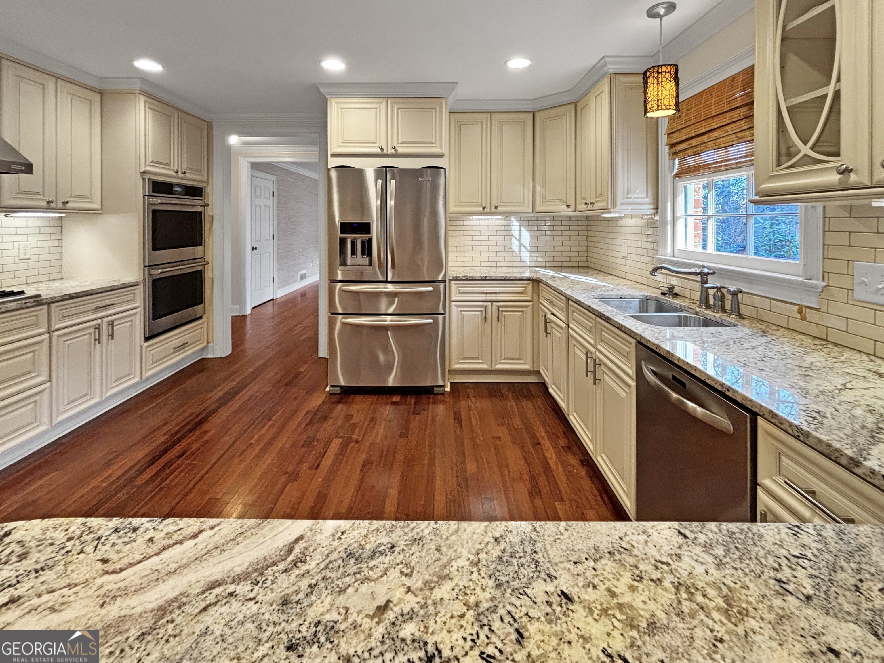 125 Mitchell Bluff Athens, GA 30606 - Photo 17 of 55 a kitchen with refrigerator cabinets and wooden floor