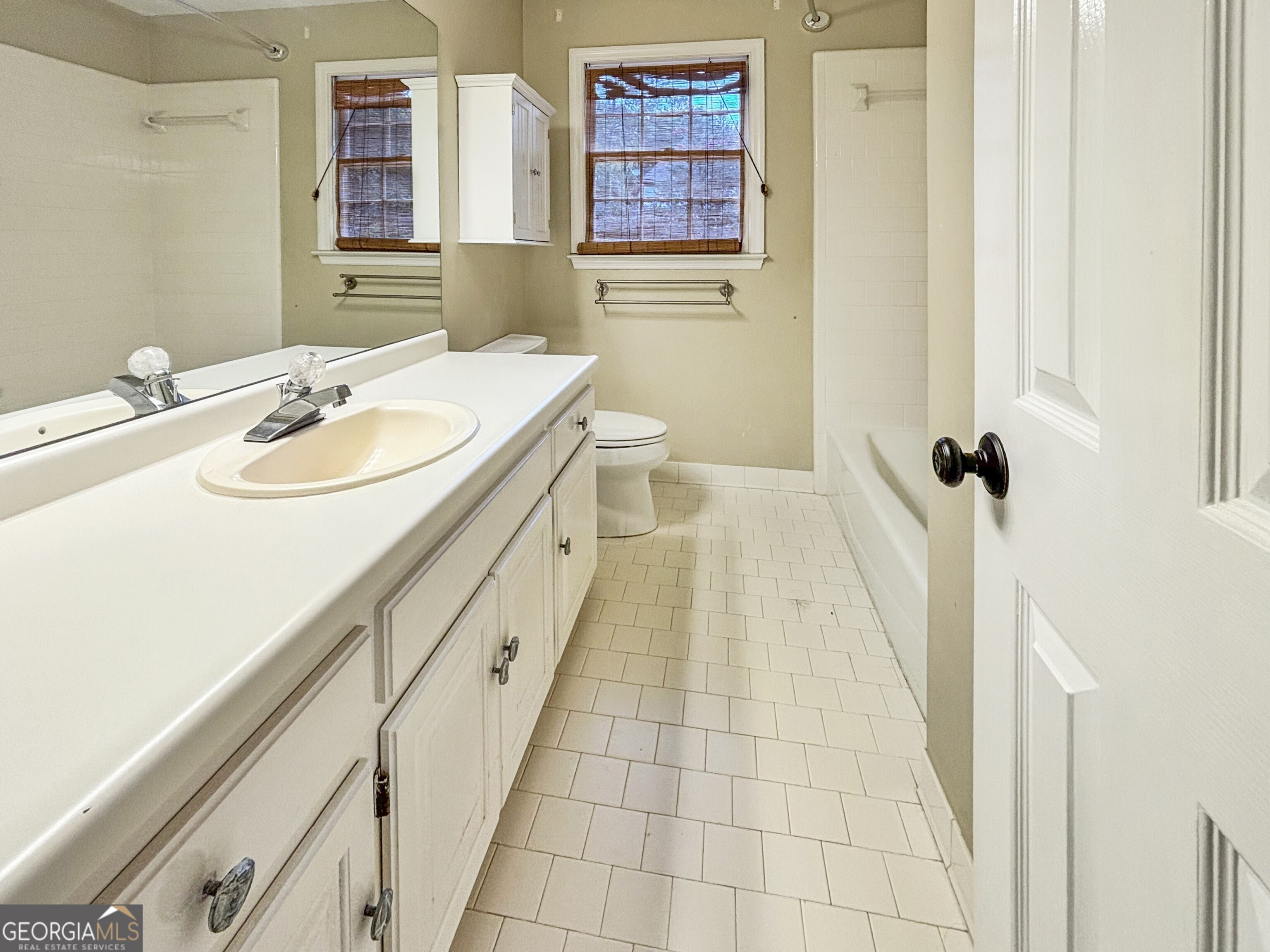 125 Mitchell Bluff Athens, GA 30606 - Photo 37 of 55 a bathroom with a sink a toilet a mirror and shower