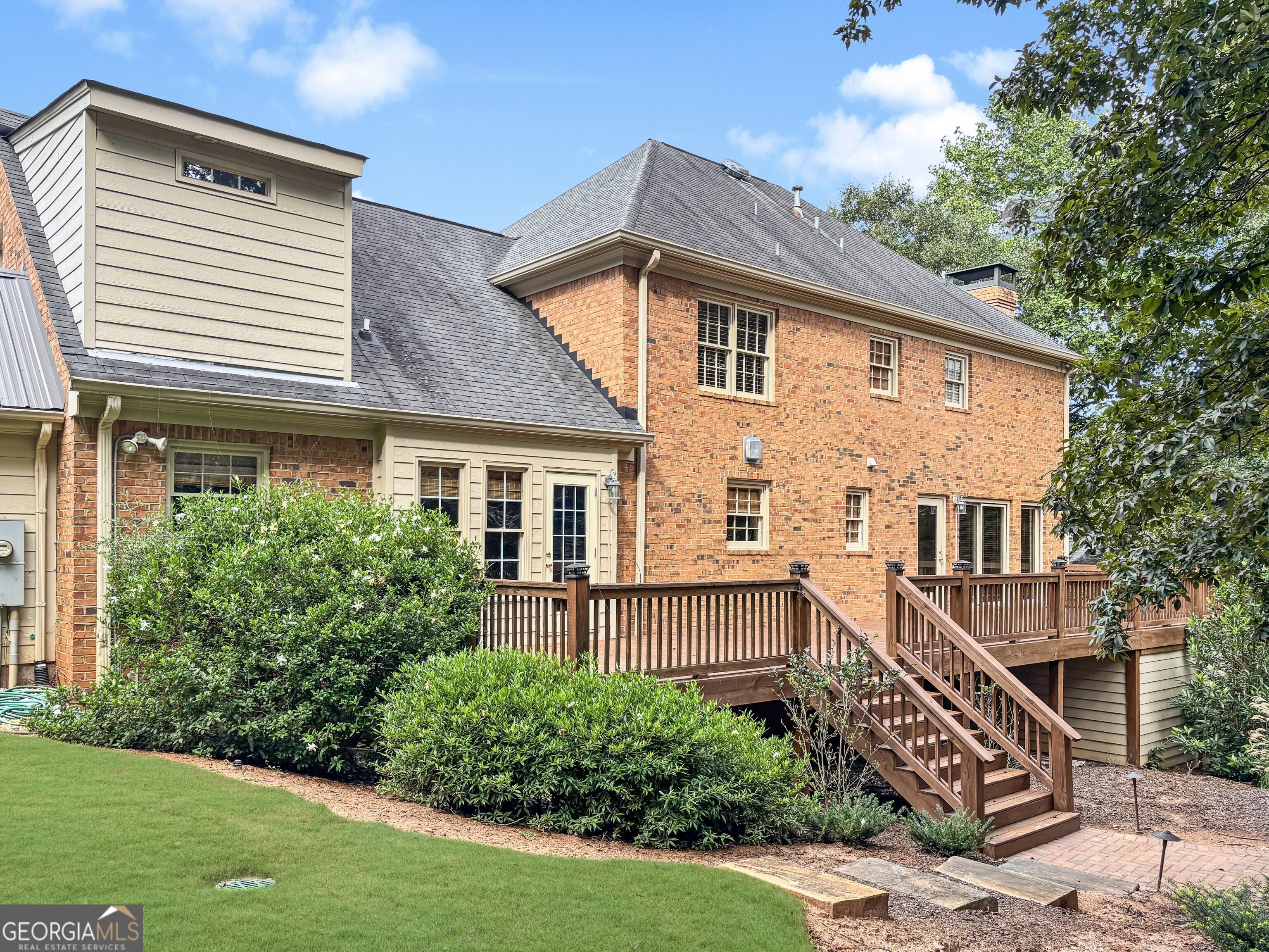 125 Mitchell Bluff Athens, GA 30606 - Photo 50 of 55 a view of a house with brick walls and a yard with plants