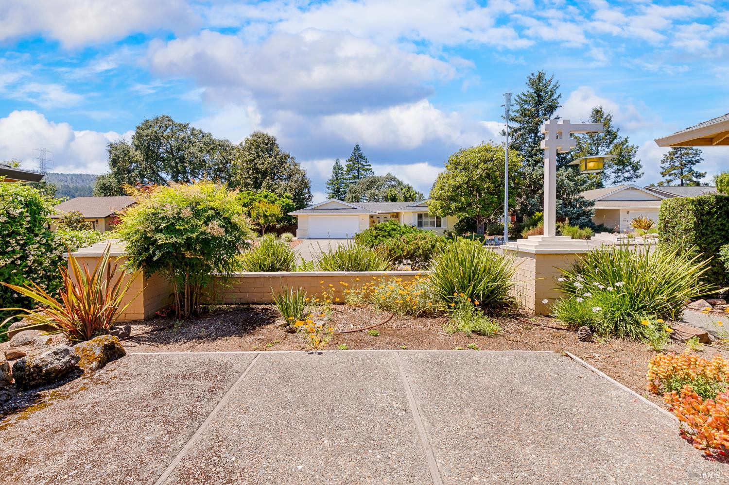 138 Oak Shadow Drive Santa Rosa, CA 95409 - Photo 5 of 50 a view of a garden with a building in the background
