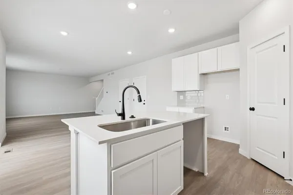 a kitchen with a sink and cabinets